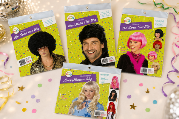 Range of costume party wigs - afro, mullet, bob and glamour styles on a decades party table