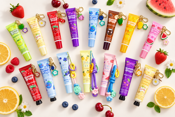 A bulk spread of flavoured lip gloss keychains in assorted colours, ready for party bags and fundraiser stalls