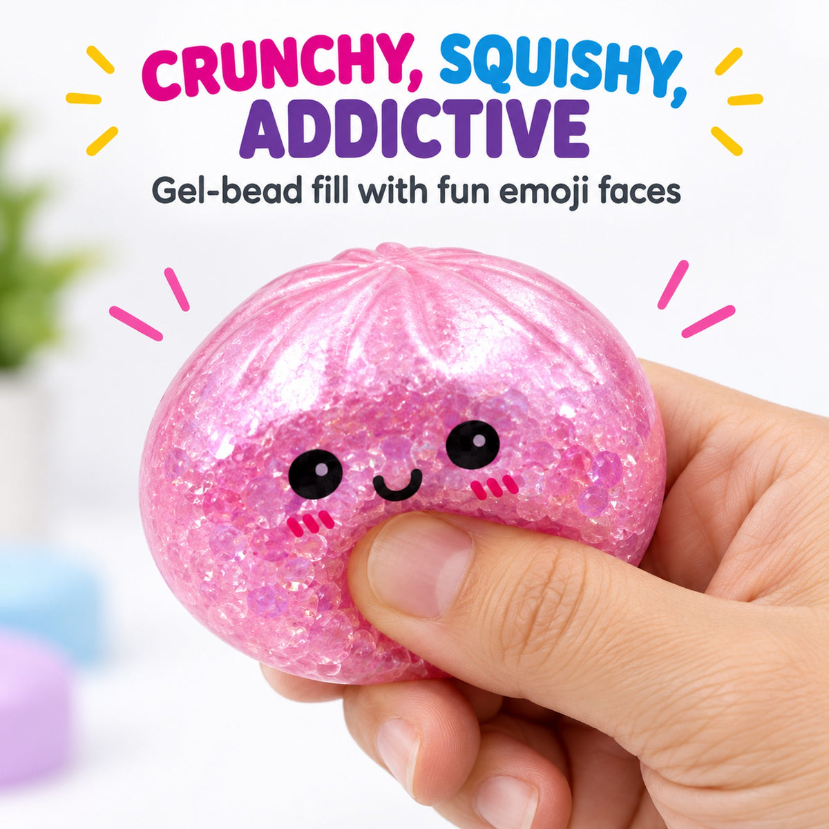 Hand squeezing a pink emoji gel-bead dumpling squishy showing the crunchy squishy texture