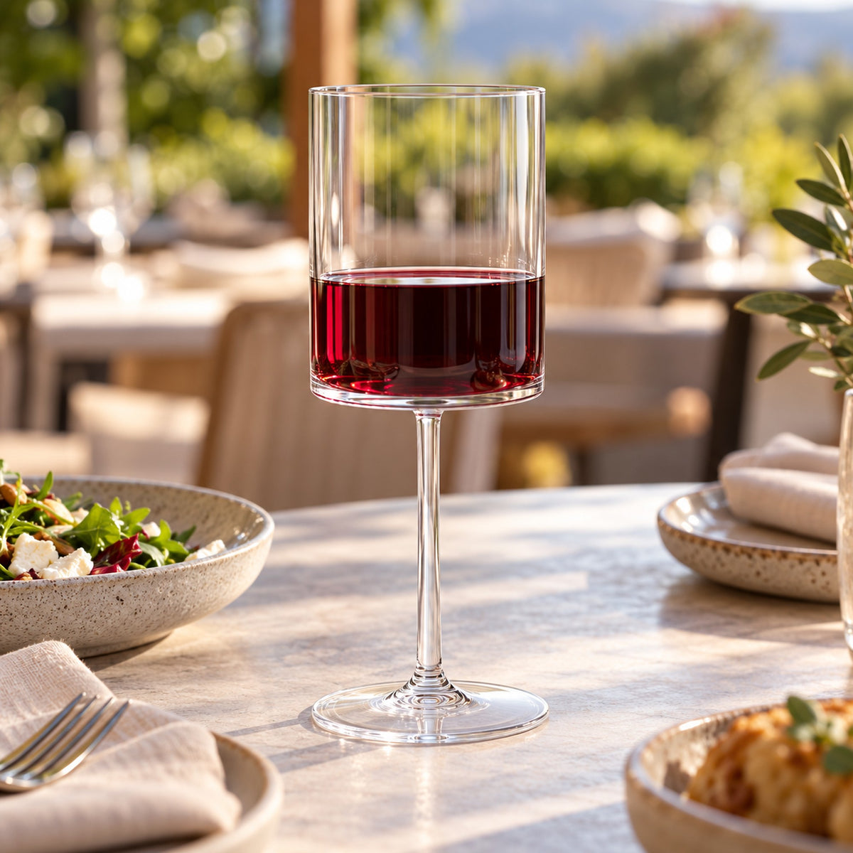 Acrylic plastic wine glass holding red wine on an outdoor restaurant dining table