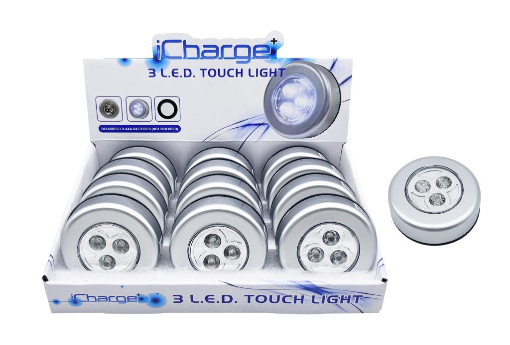 DUR8310 round LED push light 68mm diameter mounted inside a kitchen cabinet, illuminating shelf contents when pressed