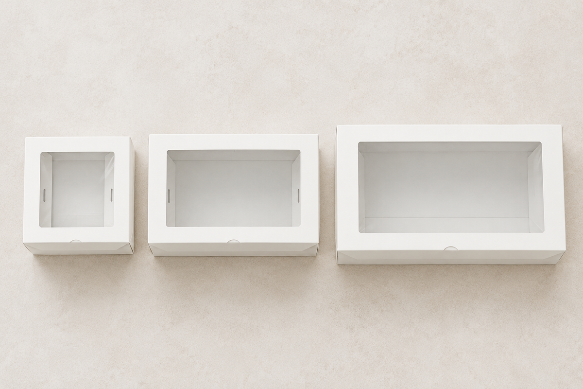 Small, medium and large empty cardboard grazing boxes side by side to compare footprint and depth