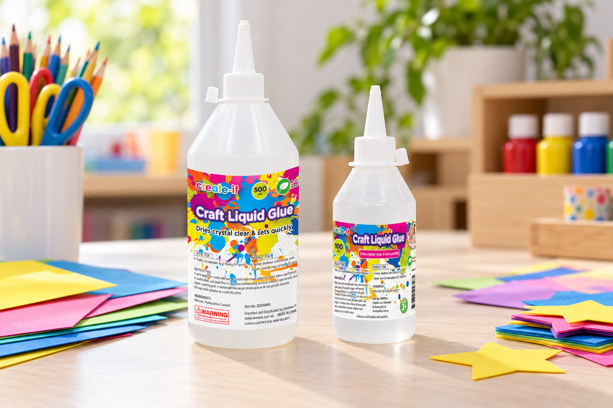 PVA and craft glue bottles beside paper and card on a school art-room bench