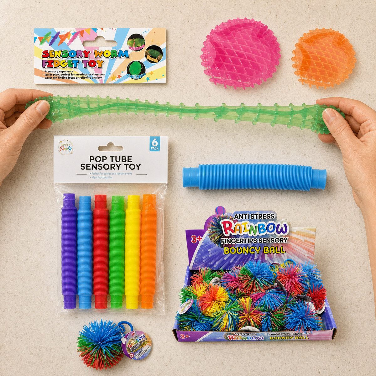 Assorted sensory and fidget toys - stretchy worms, pop tubes, stress balls and a squishy string ball